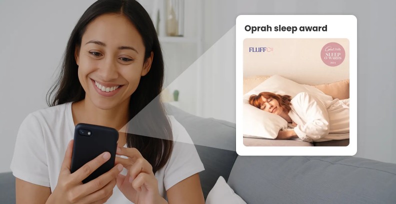 Woman smiling looking at phone with Oprah sleep award badge